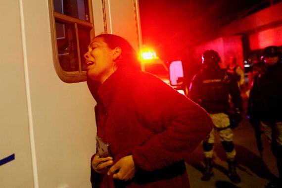 Viangly, a Venezuelan migrant, reacts outside an ambulance for her injured husband Eduard Caraballo while Mexican authorities and firefighters remove injured migrants, mostly Venezuelans, from inside the National Migration Institute (INM) building during a fire, in Ciudad Juarez, Mexico March 27, 2023