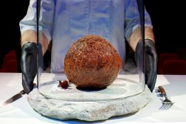 A meatball made from flesh cultivated using the DNA of an extinct woolly mammoth is presented at NEMO Science Museum [Piroschka van de Wouw/Reuters]