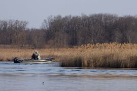 Police search the marshland where eight bodies were found in Akwesasne, Quebec, Canada [Christinne Muschi/Reuters]