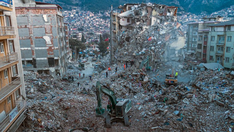 This aerial photograph taken on February 20, 2023 shows diggers removing the rubble of collapsed buildings in Antakya, southern Turkey. - A 7.8-magnitude earthquake hit near Gaziantep, Turkey, in the early hours of February 6, followed by another 7.5-magnitude tremor just after midday. The quakes caused widespread destruction in southern Turkey and northern Syria and has killed more than 44,000 people. (Photo by Sameer Al-DOUMY / AFP)