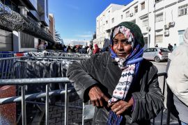 A woman looks on as she attends a gathering of sub-Saharan African migrants outside the officers of the United Nations High Commissioner for Refugees (UNHCR) in Tunis.