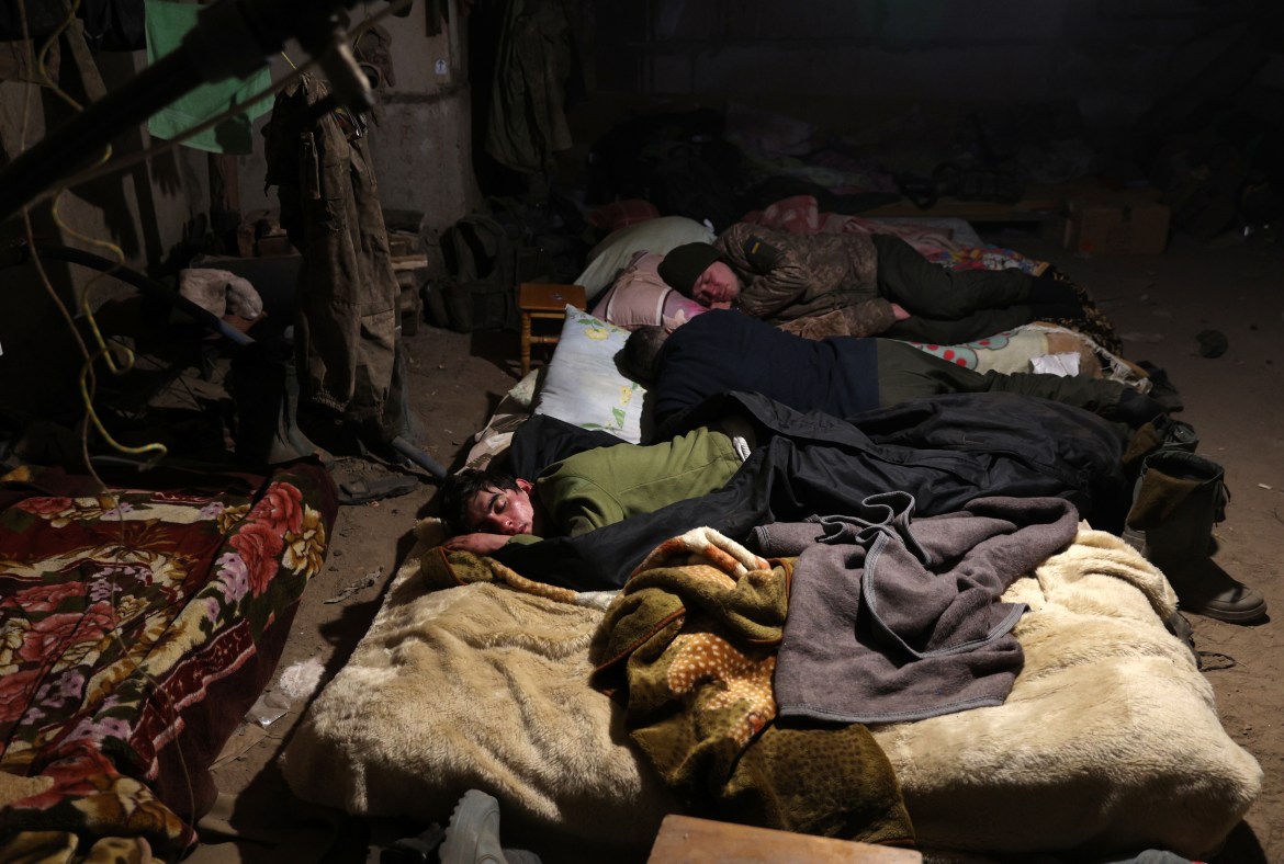 Ukrainian servicemen rest in a shelter in the town of Bakhmut, in the Donetsk region