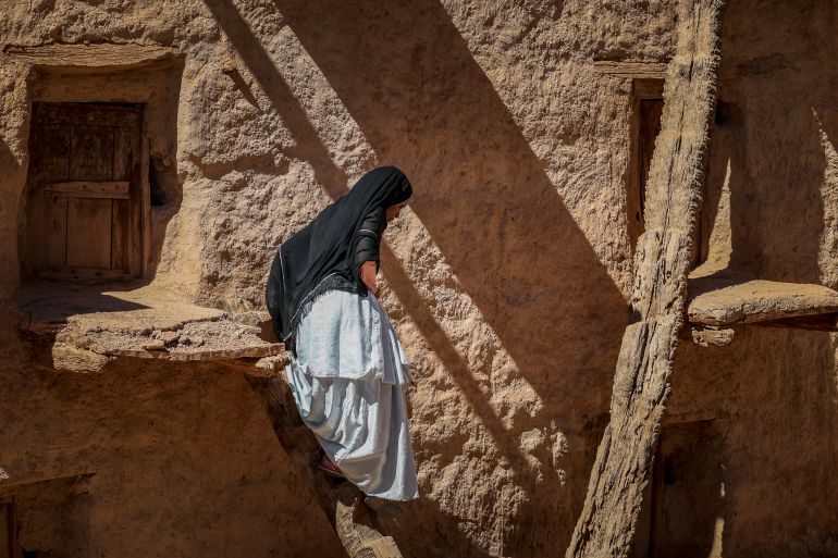 A woman walks at the ancient collective granary of Ait Kine