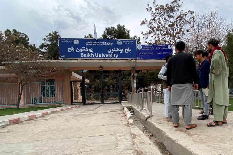 Male students arrive at the Balkh University after the universities were reopened in Mazar-i-Sharif