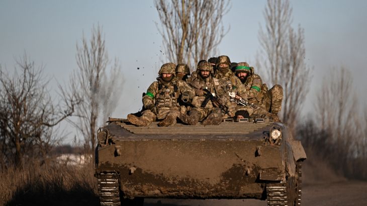 Ukrainian service members sit on a BMP military vehicle as they move towards Bakhmut in the region of Donbas, Ukraine, on March 13, 2023.