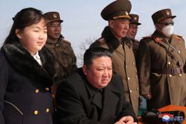 North Korea&#39;s leader Kim Jong Un, centre, and his daughter, left, observe a warhead missile launch exercise in this image released by the official Korean Central News Agency (KCNA) on March 20, 2023 [KCNA via KNS/AFP]