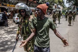 A Kenyan Police officer arrests a protester following clashes with opposition supporters in Nairobi, Kenya on March 20, 2023