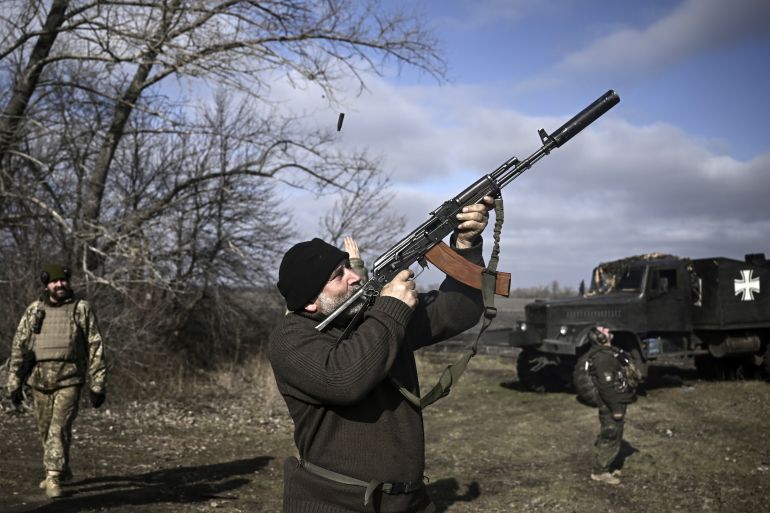 A Ukrainian service member with a long rifle shoots at a drone in Bakhmut, Ukraine.