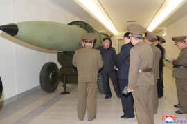 Kim Jong Un, centre, inspecting a nuclear weapons programme at an unknown location in North Korea in this picture taken on March 27, 2023, and released by North Korea&#39;s official Korean Central News Agency on March 28, 2023 [KCNA via KNS/AFP]
