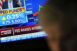 News on a Federal Reserve interest rate hike appears on a monitor at the New York Stock Exchange