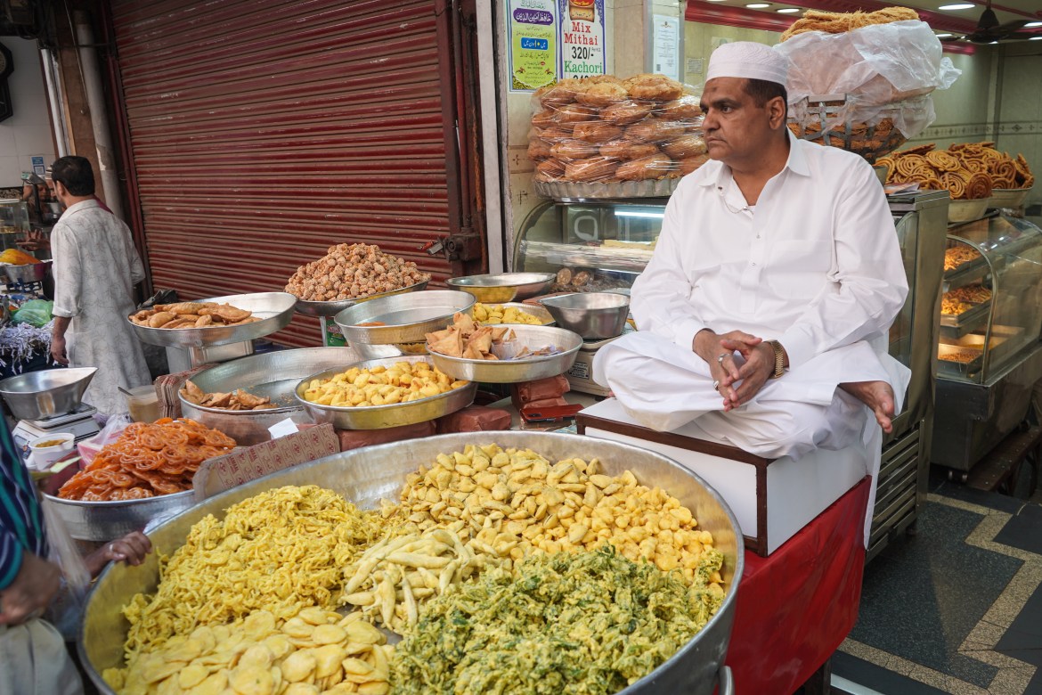 A Muslim man in Jama Masjid Market selling a variety of traditional snacks and sweets prepared particularly for Ramadan.