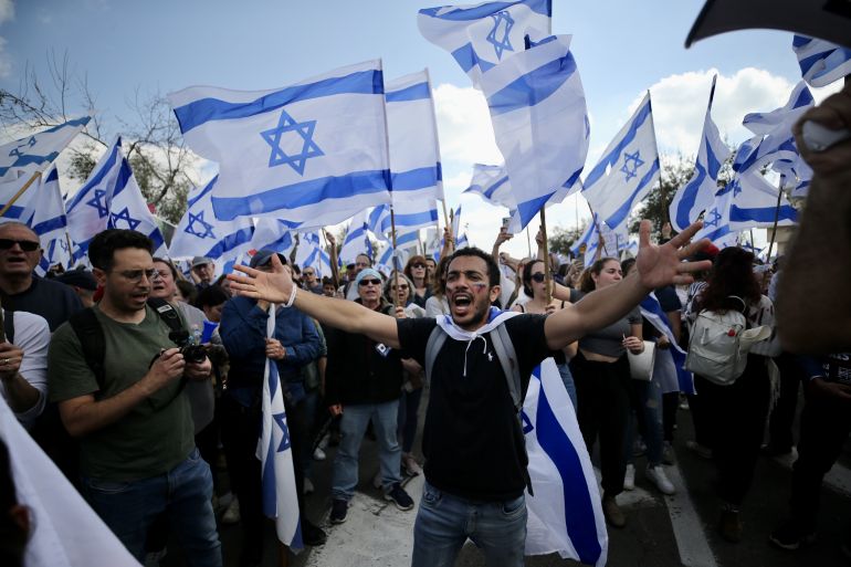 Israelis protest during a demonstration after Israeli Prime Minister Benjamin Netanyahu dismissed the defence minister