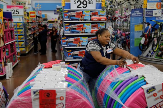 Balo Balogun labels items in preparation for a holiday sale at a Walmart Supercenter, in Las Vegas, Nevada, US