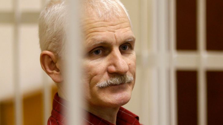 Ales Bialiatski, the head of Belarusian Vyasna rights group, stands in a defendants' cage during a court session in Minsk, Belarus