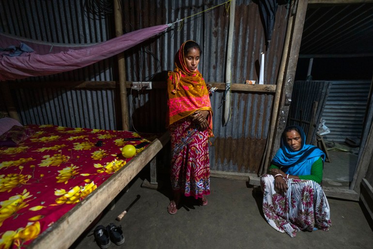 Radha Rani Mondal, 50, right, with her daughter in law Mampi Biswash sit in their shanty home