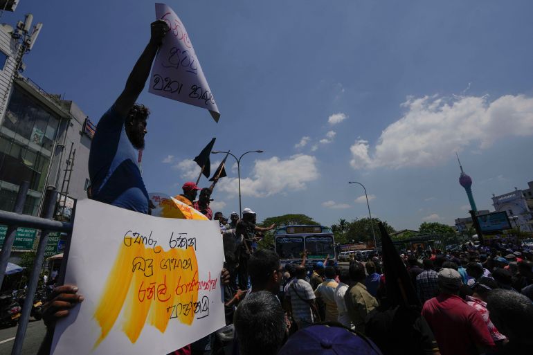 Sri Lankans shout slogans during a protest against the government increasing income tax to manage day to day expenses amid an unprecedented economic crisis in Colombo, Sri Lanka, Wednesday, Feb. 22, 2023. The government says it has been forced to increase taxes because of a severe cash crunch and the success of its talks with the International Monetary Fund depends on a strong public revenue structure. (AP Photo/Eranga Jayawardena)