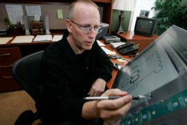 Scott Adams, creator of Dilbert, works on his comic strip in his studio in in Dublin, California, on October 26, 2006. Syndication company Andrews McMeel announced they were severing ties with Adams after his comments about race on his YouTube show, Real Coffee with Scott Adams [File: Marcio Jose Sanchez/AP Photo]