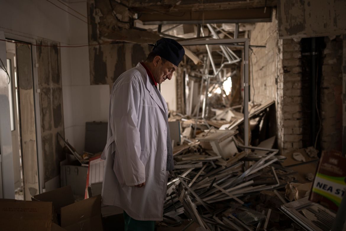 Ukrainian doctor Yurii Kuznetsov pauses in the destroyed surgery section of the hospital in Izium