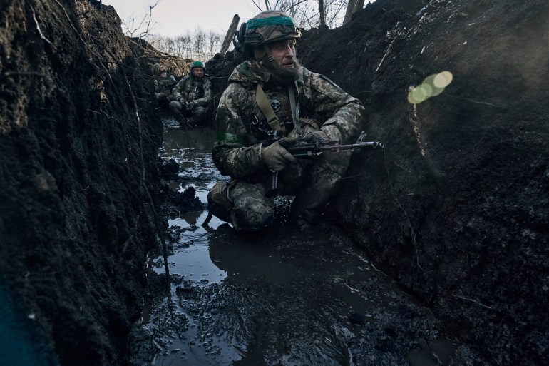 Ukrainian soldiers in a trench under Russian shelling on the frontline close to Bakhmut, Donetsk region, Ukraine