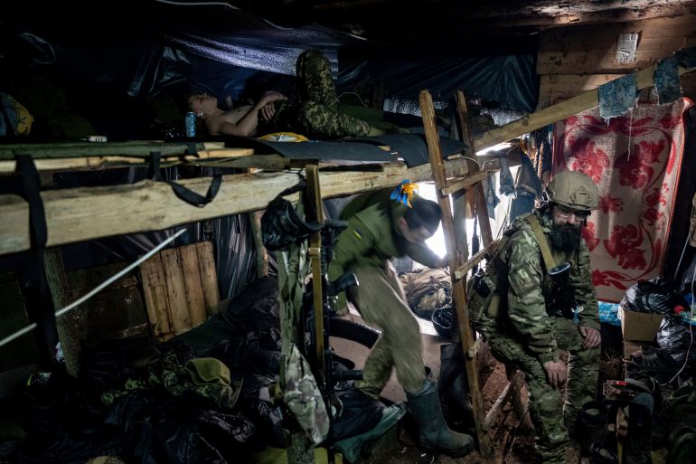 Soldiers in a dig out near the front line in Bakhmut, Ukraine. They are resting on bunks.