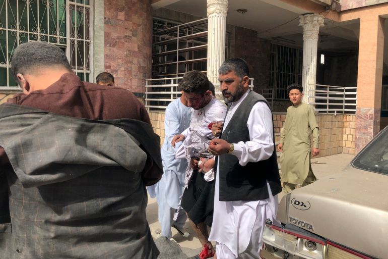 An injured man is rescued after a blast in Mazar-e-Sharif in Afghanistan