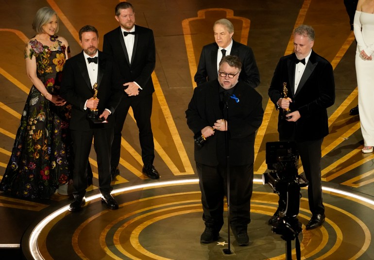 Guillermo del Toro centerstage accepting an Oscar