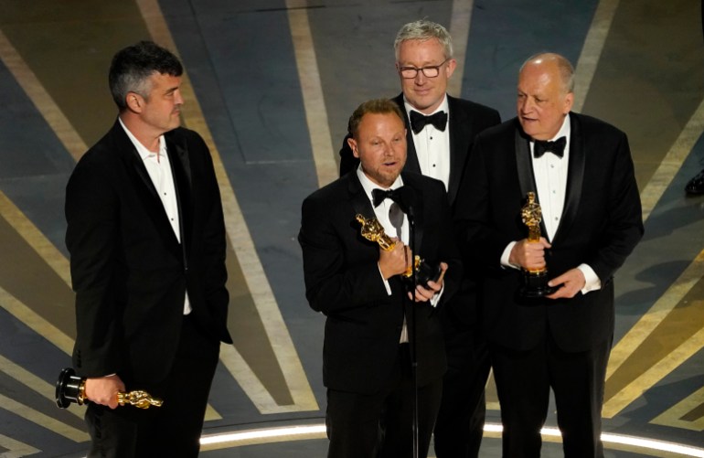 Eric Saindon, from left, Richard Baneham, Daniel Barrett and Joe Letteri accept the award for best visual effects