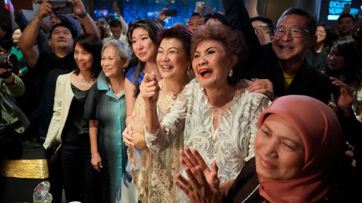 Janet Yeoh, second right, mother of Michelle Yeoh, celebrates after her daughter won in the best actress category during the 95th Academy Awards in Los Angeles