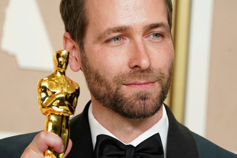 A close up of a man with an Oscar