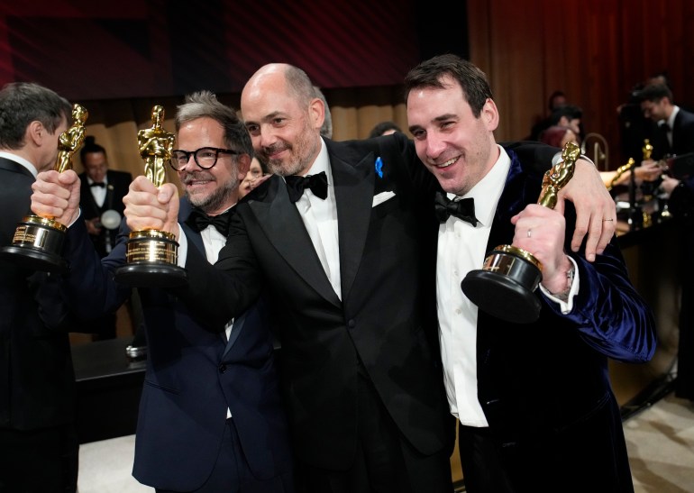 Christian M. Goldbeck, from left, winner of the award for best production design for "All Quiet on the Western Front," Edward Berger, winner of the award for best international film for "All Quiet on the Western Front," and James Friend, winner of the award for best cinematography for "All Quiet on the Western Front"