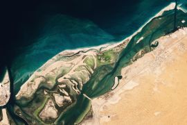 This satellite image from Planet Labs PBC shows Siniyah Island in Umm al-Quwain, United Arab Emirates [Planet Labs PBC via AP]