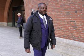 Former Haitian Mayor Jean Morose Viliena departs a federal court in Boston, Massachusetts, where he was ordered to pay $15.5m for violently targeting political opponents [Steven Senne/AP]