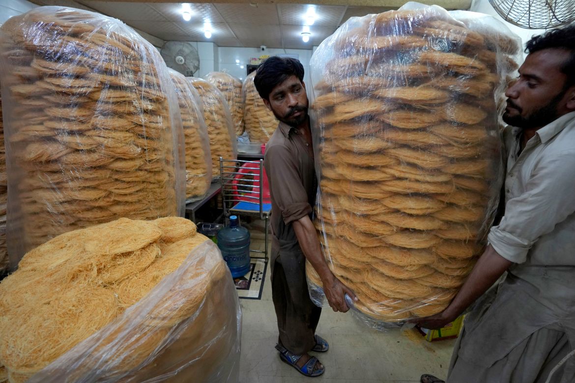 Workers carry vermicelli, a special delicacy prepared for the upcoming Muslim fasting month of Ramadan, in Karachi, Pakistan