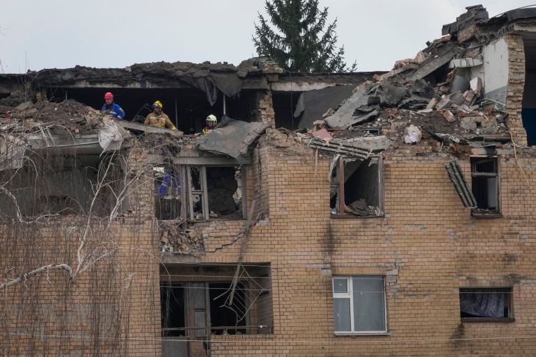 Emergency personnel work at a damaged building