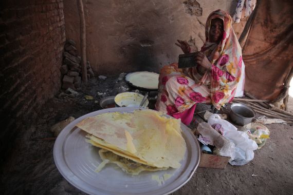Sudanese women prepare Al-Raqqa, a Ramadan drink made with dried corn and spices which is in the milk, in Khartoum, Sudan