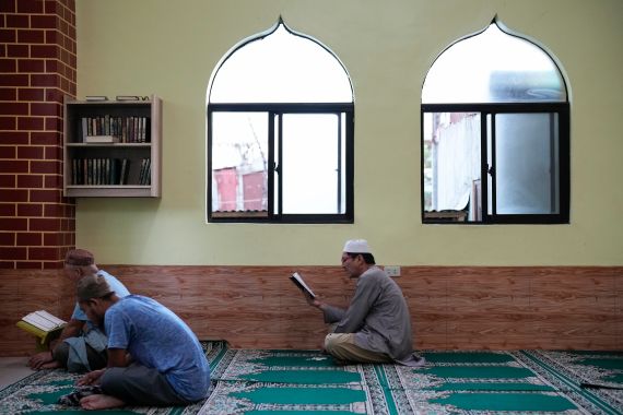 A Filipino Muslims read the Quran inside a mosque on the first day of the Muslim holy fasting month of Ramadan in Marikina, Philippines