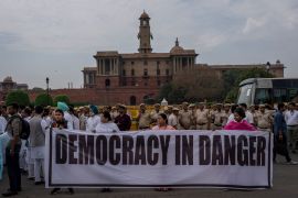 Politicians from India&#39;s opposition Congress and other parties hold a banner as they march against the Narendra Modi-led government alleging that Indian democracy is in danger, outside India&#39;s parliament in New Delhi, India, on Friday, March 24, 2023. Congress party leader Rahul Gandhi lost his parliamentary seat as he was disqualified following his conviction by a court that found him of guilty of defamation [Altaf Qadri/AP Photo]