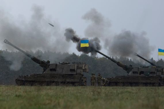 Ukrainian soldiers fire an AS90 as they take part in a military exercise at a military training camp in an undisclosed location in England, Friday, March 24, 2023. The second cohort of Ukrainian artillery recruits come to the end of their training on the formidable AS90 155mm self-propelled gun. (AP Photo/Kin Cheung)