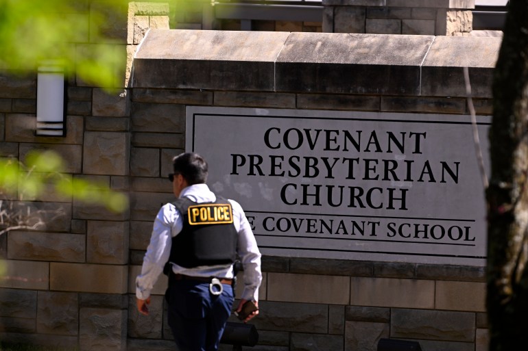 A police officer walks by an entrance to The Covenant School after the shooting in Nashville, Tennessee.
