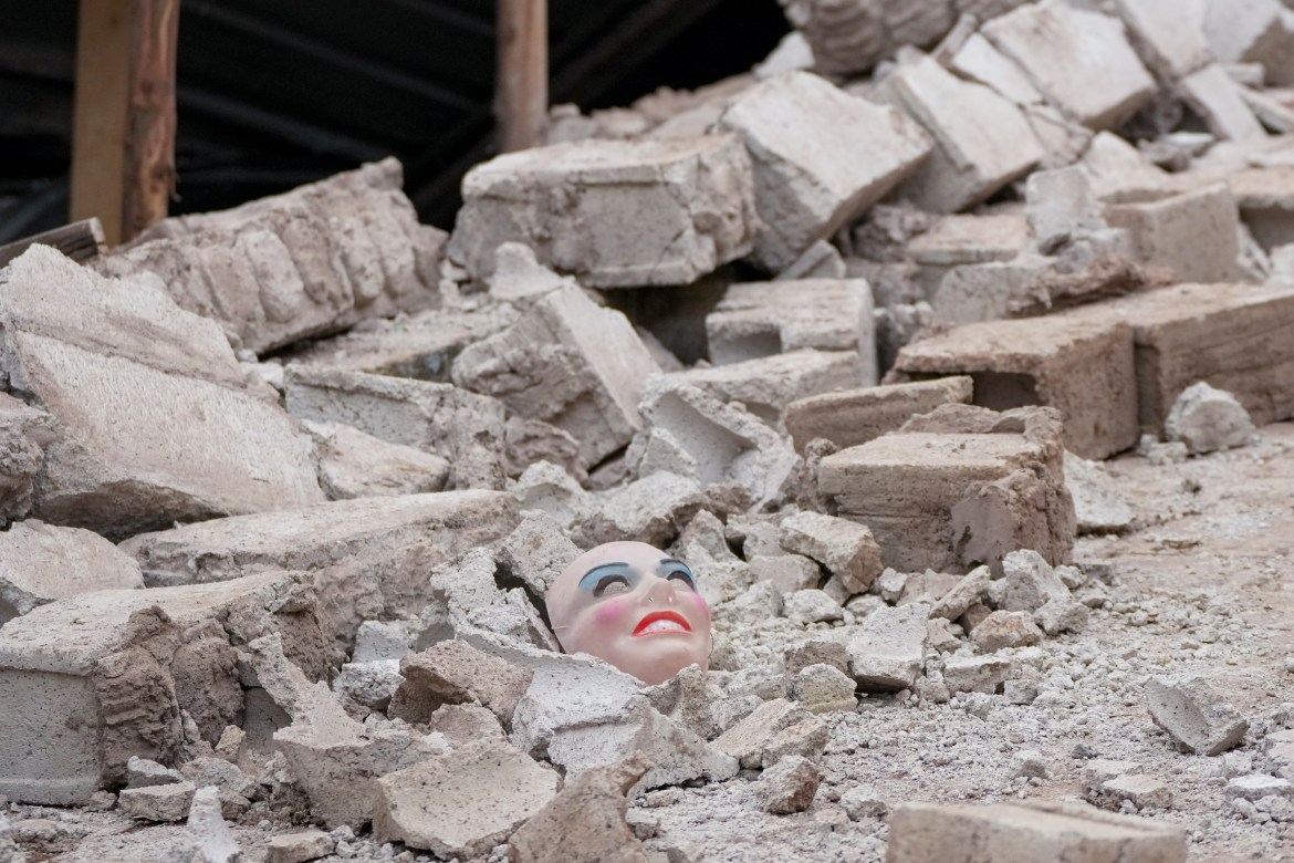 A mask lays on the rubble of a building destroyed after a deadly landslide in Alausi, Ecuador