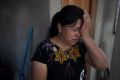 Ana Marina Lopez, wife of Guatemalan migrant Bacilio Sutuj Saravia who was at a Mexican immigration detention center during a fire, cries