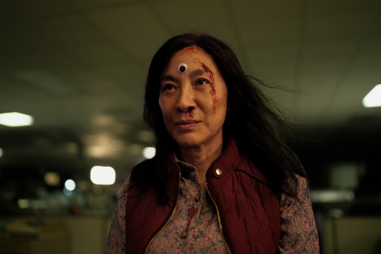 Michelle Yeoh with a googly eye on her forehead