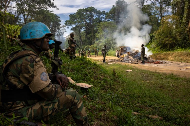 KILYA, RWENZORI SECTOR, DEMOCRATIC REPUBLIC OF THE CONGO - APRIL 09: Congolese Army Soldiers and UN troops inspect an ambush site where an hour previously ADF fundamentalist rebels attacked two vehicles on the road between Beni and the Ugandan border town of Kasindi, on April 9, 2021 in Kilya, Rwenzori Sector, Democratic Republic of the Congo. ADF killed three civilians in the vehicles, assassinating them with shots to the head outside of their vehicles, there was also evidence of cuts from machetes. The Malawian contingent of the UN’s MONUSCO force arrived on scene as the ambush was ending and the vehicles were being set on fire. They engaged a large force of ADF fighters, killing one of them. That fighter was stripped of his uniform by other ADF fighters during the firefight, they then fled into the jungle. The purpose of the ADF’s attacks is to spread terror amongst the civilian population. There have been multiple attacks across the province by ADF, all characterized by brutality and on occasion, beheadings. The ADF is an Islamic terror group based out of Eastern DR Congo that, in recent years, has developed a relationship with the Islamic State after pledging allegiance to ISIS leadership. They are known locally as ISIS in Congo.
