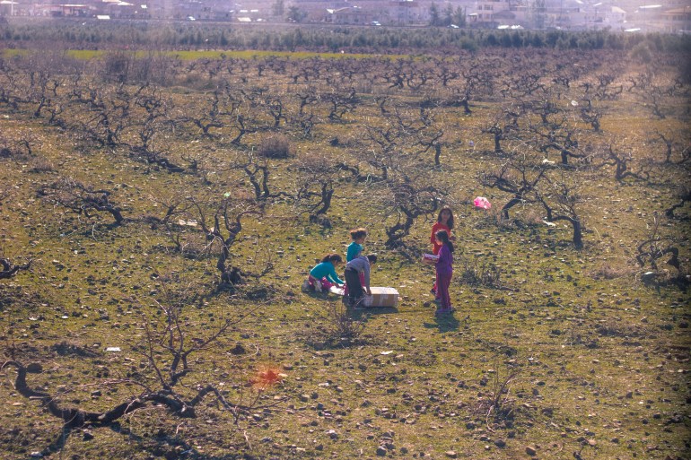 Syrian girls play out among the trees in Gazikent.