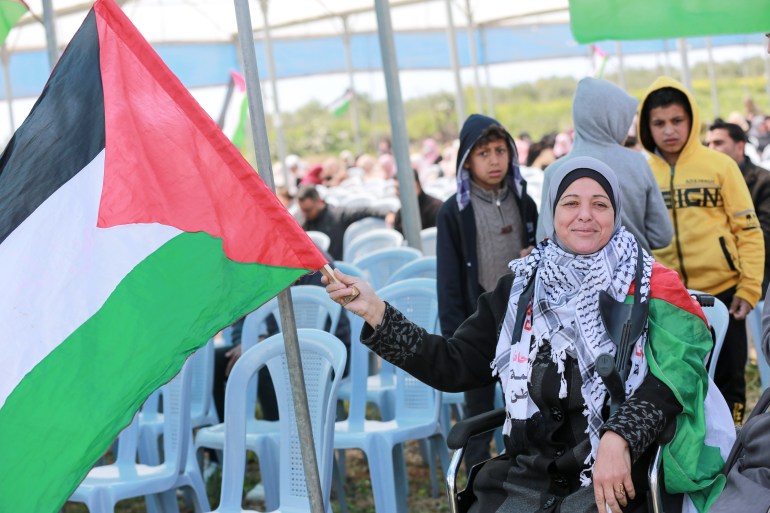 A woman raising the Palestine flag
