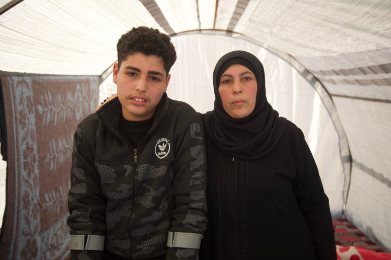 Moufida Ghanem and her son Ali in their tent