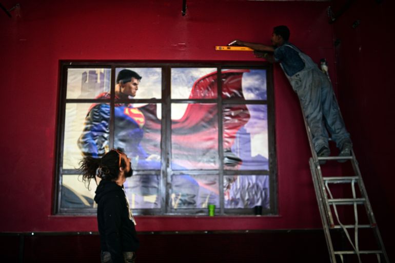 A migrant and an volunteer work at the newly staged refugee and migrants multi-culture center ,at the island of Lesbos on March 15, 2017. The center is run by a Swiss Cross volunteers group and built with the help of migrants from mainly Moria camp and local solidrity groups . Almost a year after the EU-Tukey deal and the closing of the borders more than 14000 refugees and migrants are stuck at Aegean islands, out of 62000 in the country. The deal, signed on March 18, 2016 has sought to stem the flow of migrants from Turkey to the EU, in particular Greece, by land and sea routes.AFP PHOTO/ Louisa GOULIAMAKI
