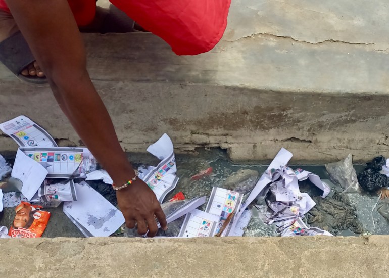 Ballots papers lay trampled in a gutter on Adedoyin Road in Lagos.