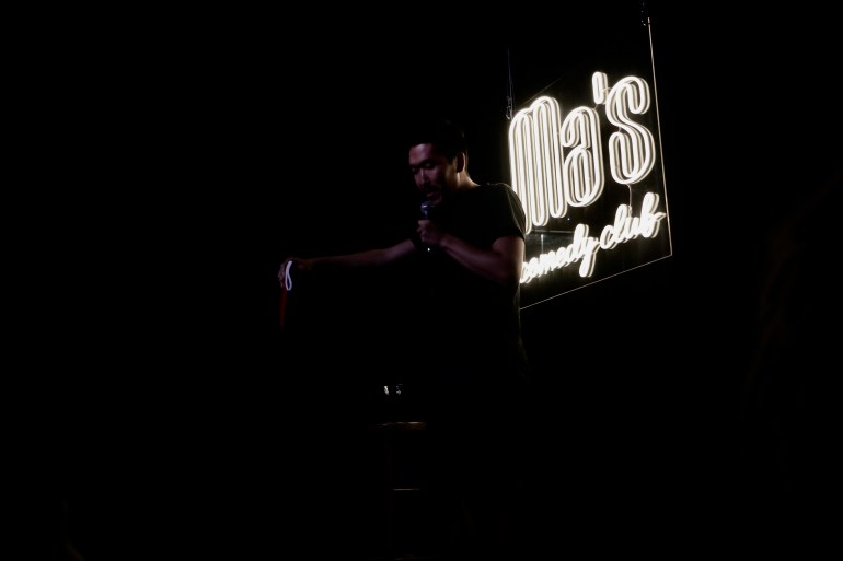 A photo of Nikita performing at a comedy club.
