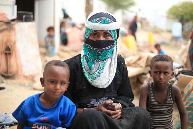 Baheyah Abdu is seen with two of her children at an IDP camp in Yemen